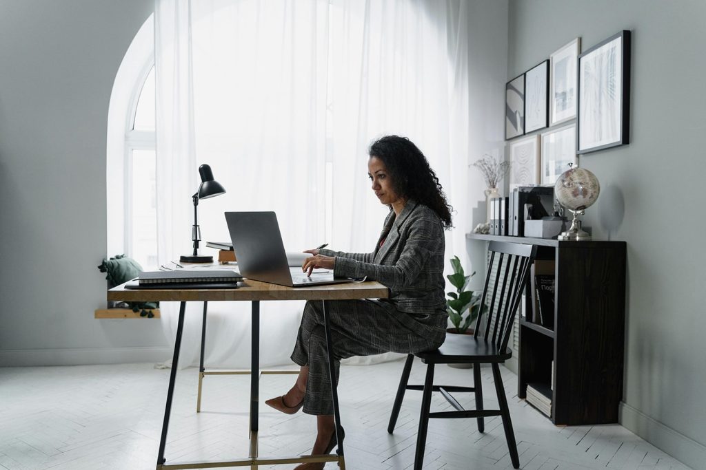 Woman on her laptop, sitting in her home office
