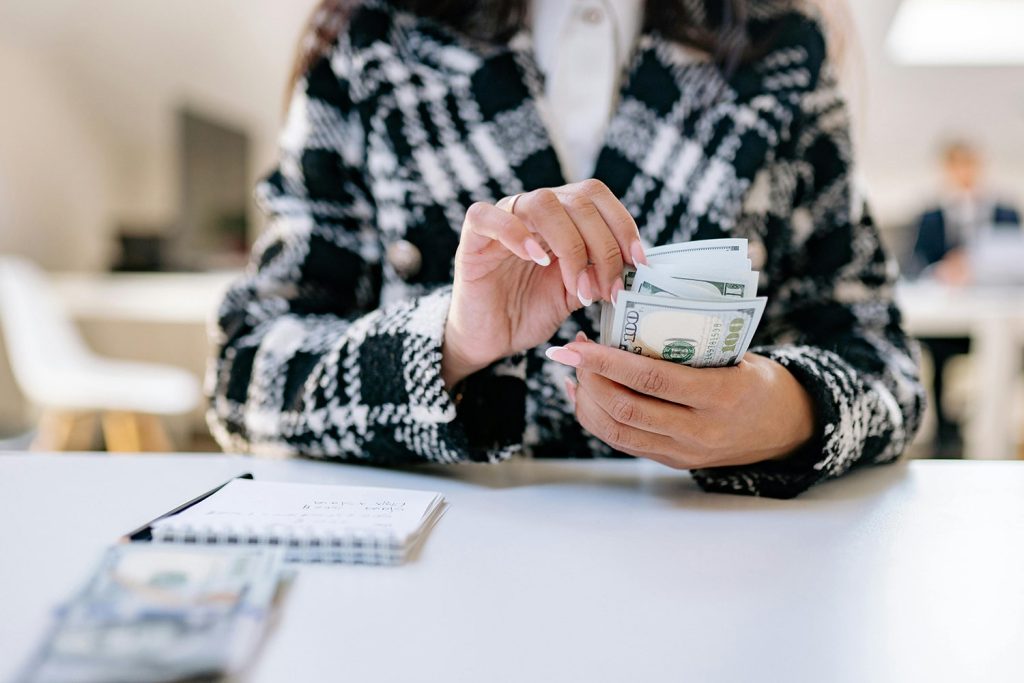 Woman in business suit, counting money