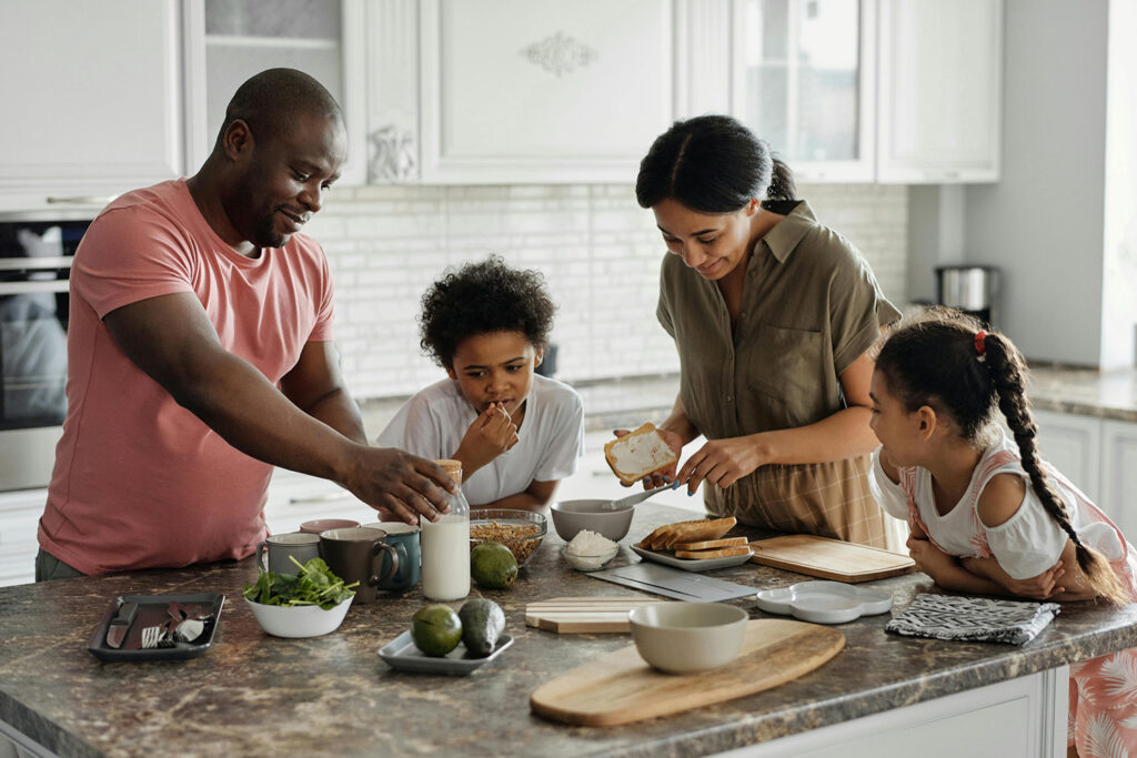 Family of four in the kitchen together