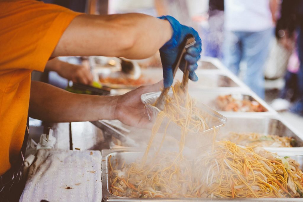 Noodles being prepped by a food truck worker