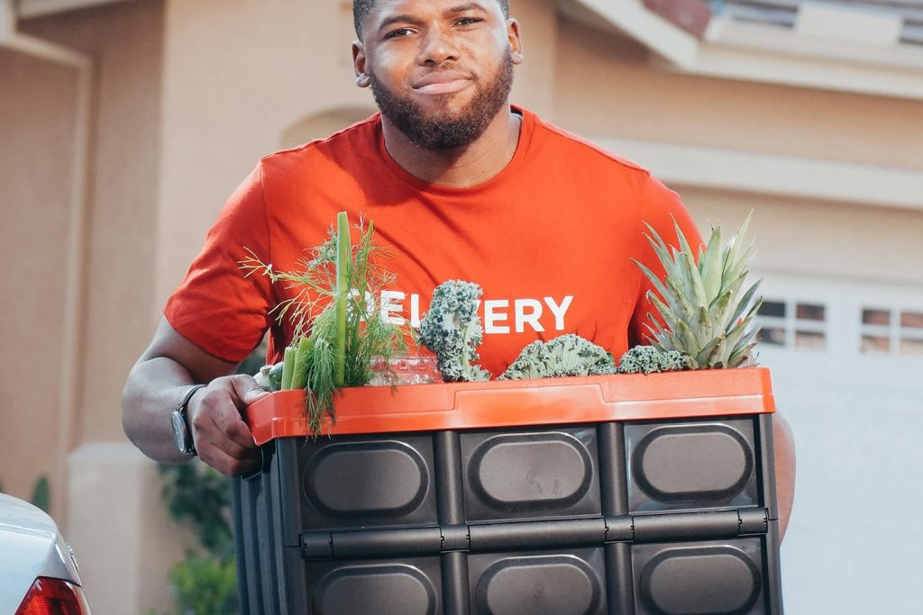 A younger man delivering plants