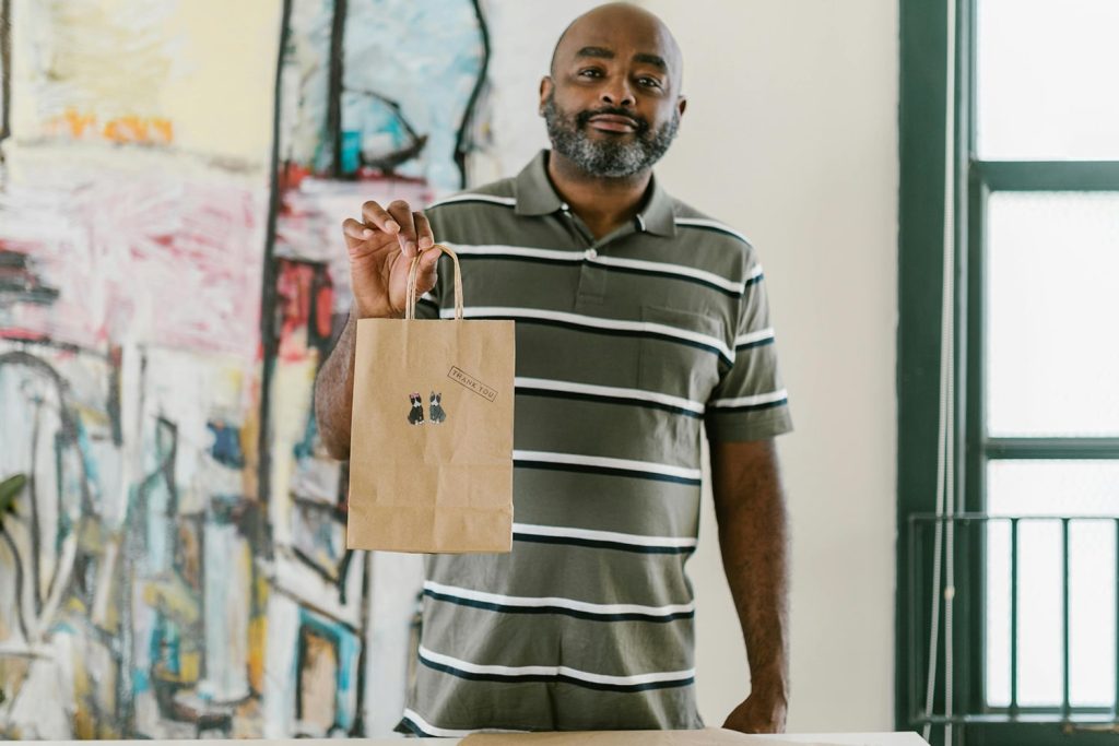 Middle-aged man holding a small bag