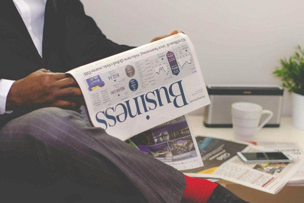 Man reading the business section of a newspaper