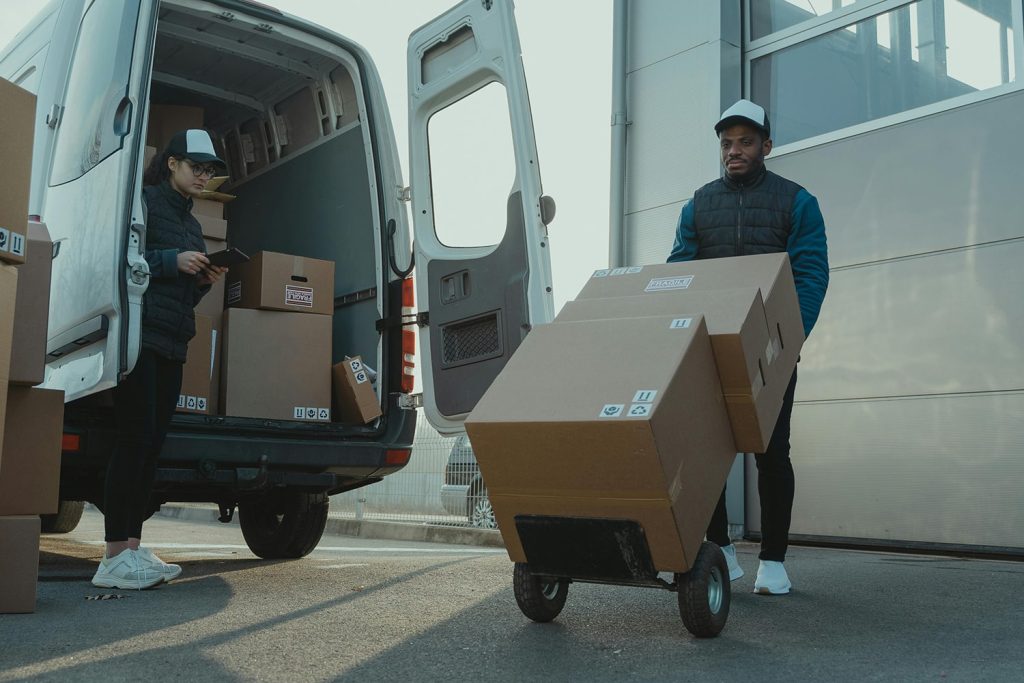 Man using folding dolly to move boxes and packages out of truck