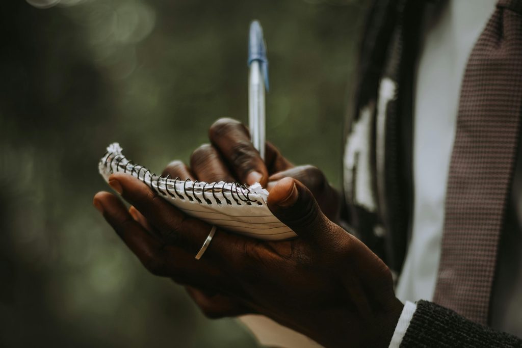 Man writing in his notepad