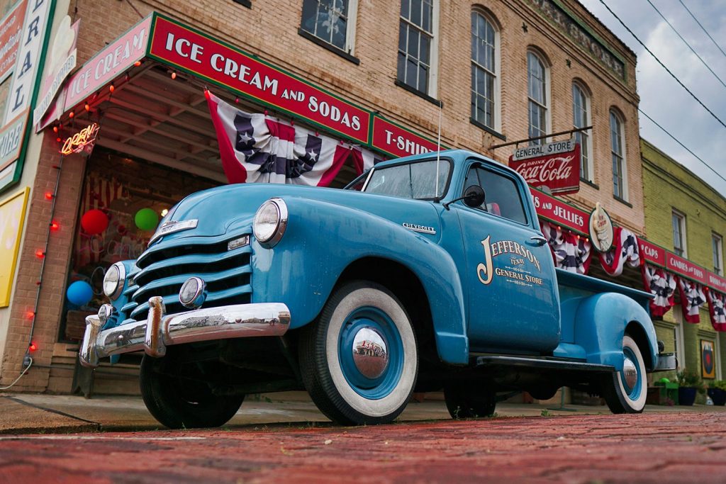 Old school truck parked near small town store