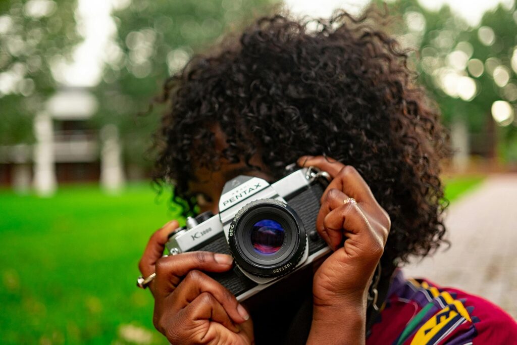 Front view of a woman holding her camera