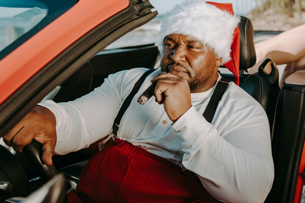 A man dressed in Christmas outfit, with a cigar