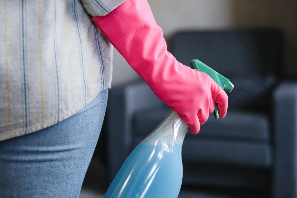Woman holding a spray bottle for spring cleaning