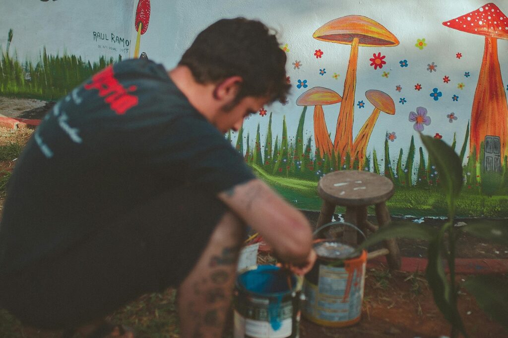 Man painting a small mural